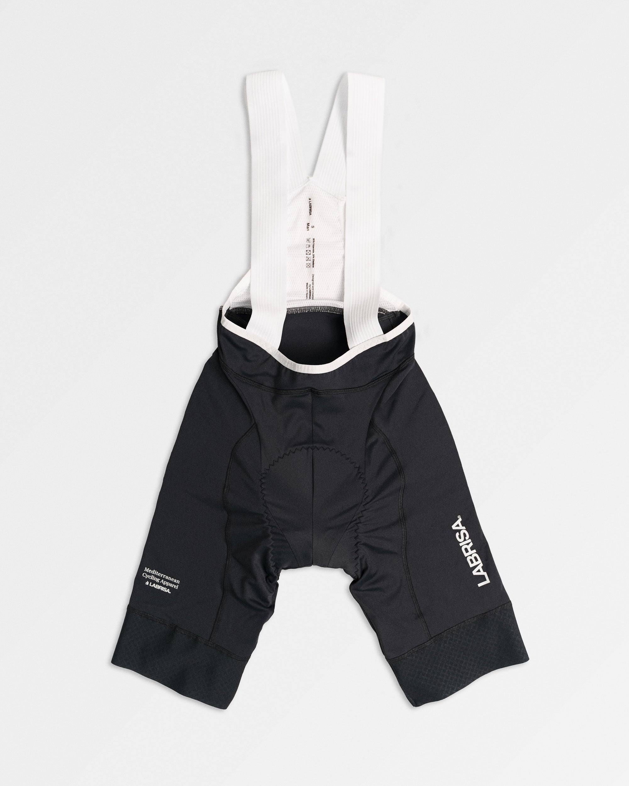 Imagen de culotte de ciclismo de hombre gris. Logotipos en blanco de LABRISA en la pierna izquierda y el tagline de Mediterranean Cycling Apparel en la derecha. Los tirantes son blancos y el vivo son blancos.