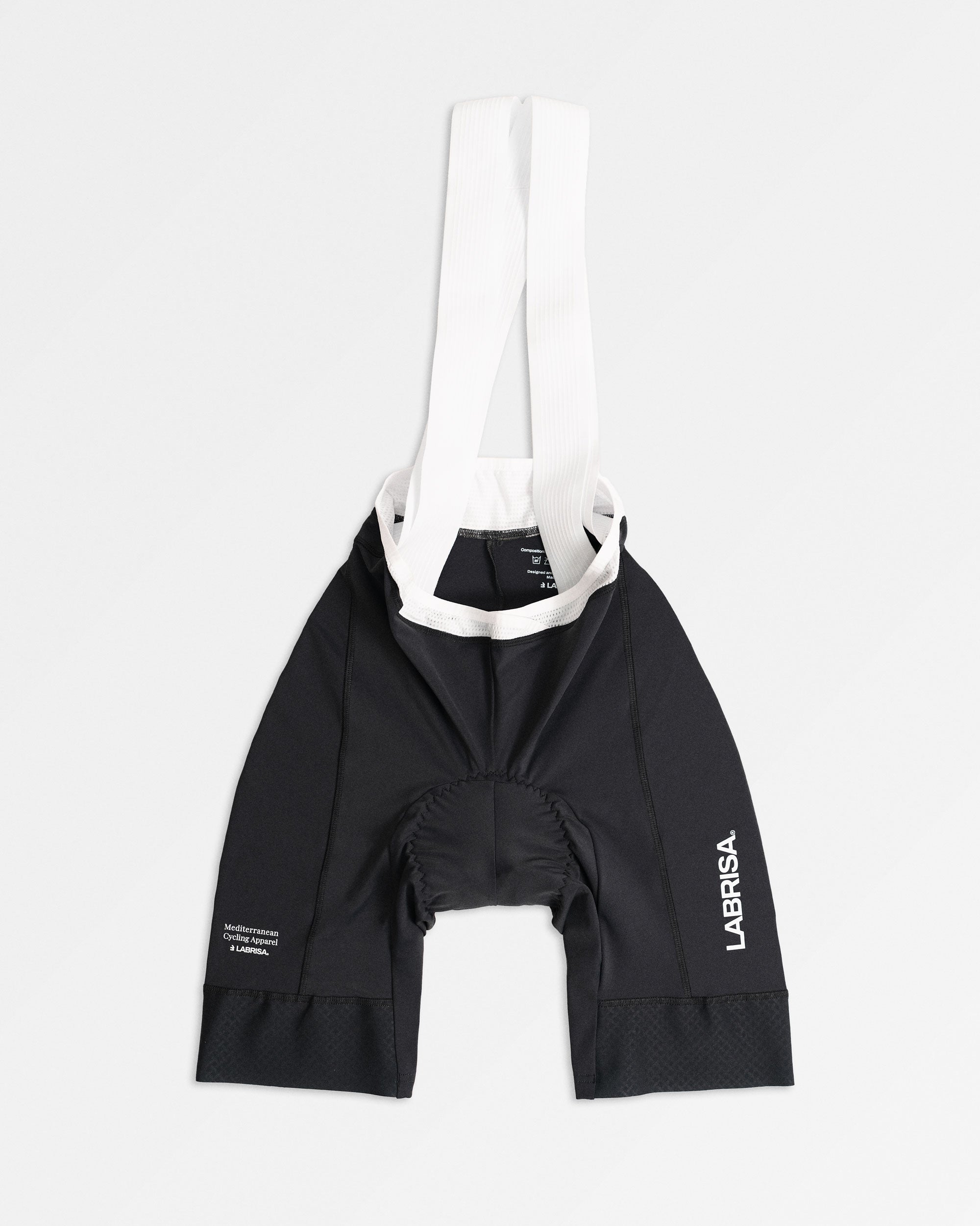Imagen del culotte de ciclismo de chica gris. Logotipos en blanco de LABRISA en la pierna izquierda y el tagline de Mediterranean Cycling Apparel en la derecha. Los tirantes son blancos y el vivo es blanco. 